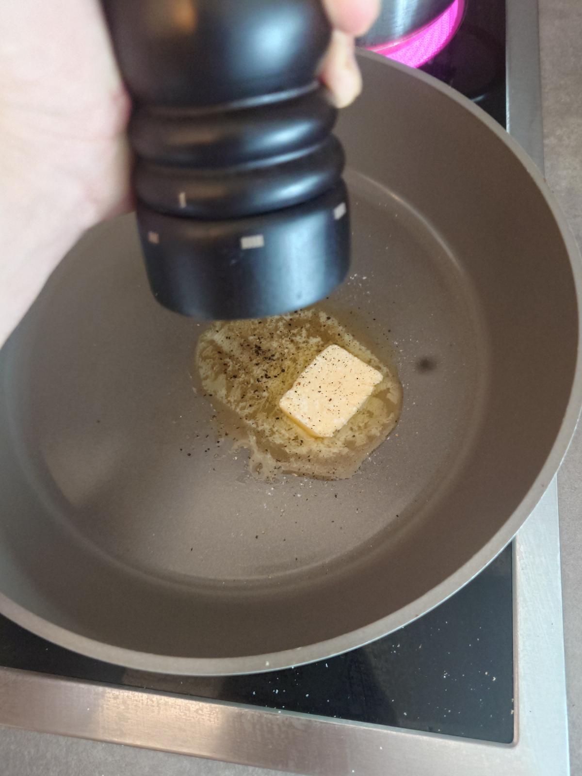 Black pepper ground onto the butter