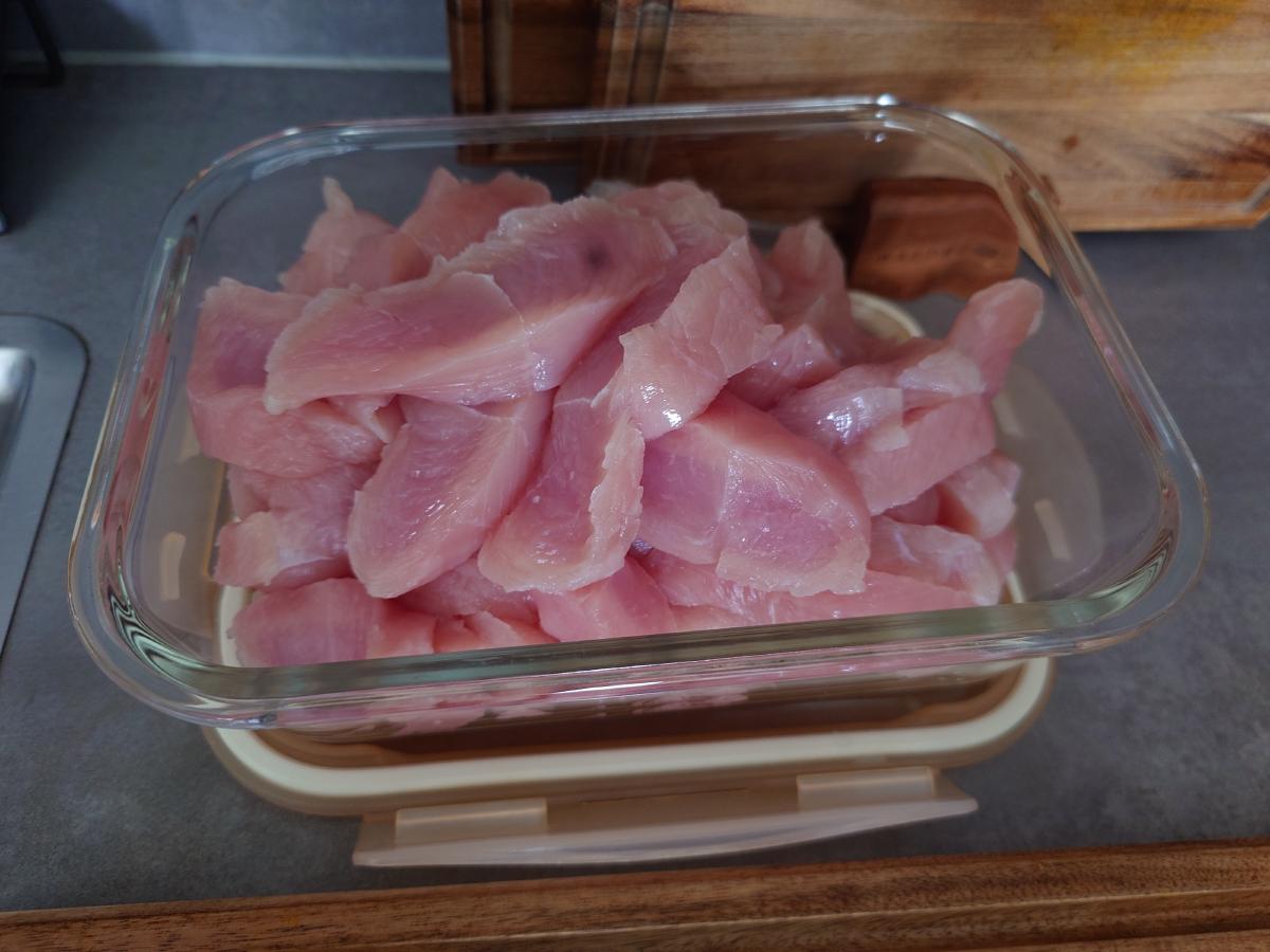 Turkey breast sliced into strips in a glass container