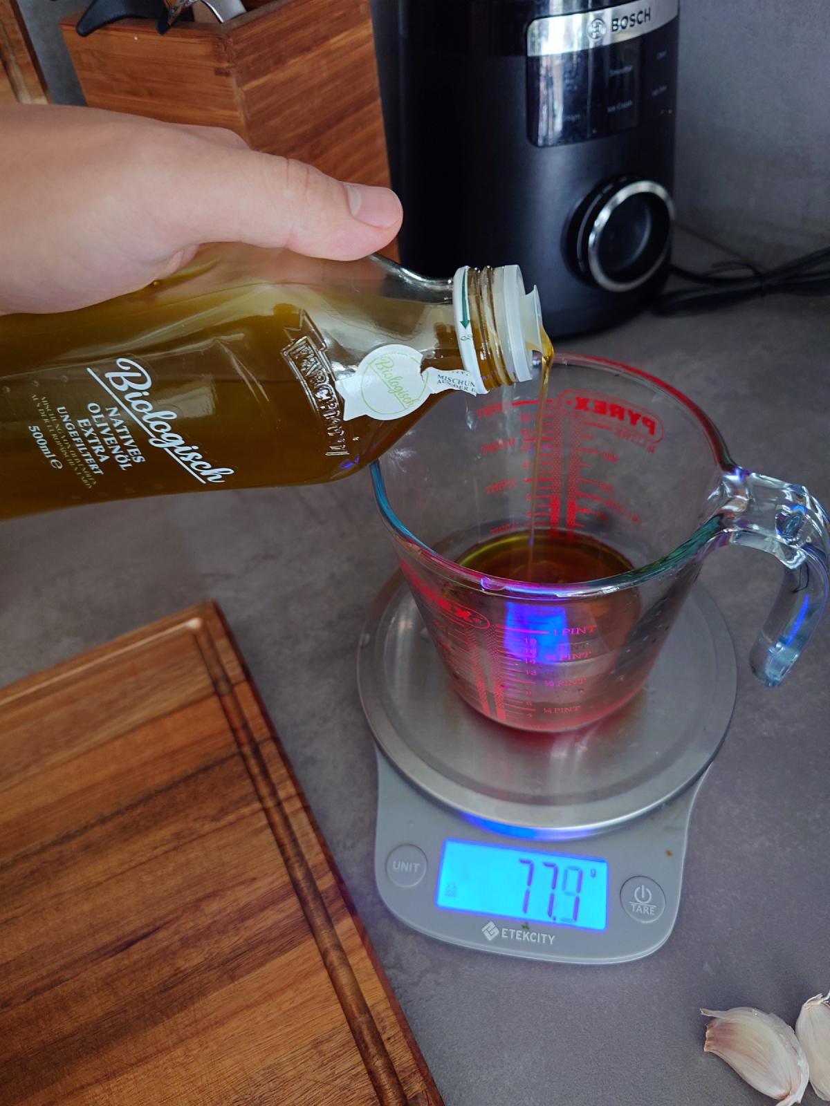 Olive oil poured into the cup