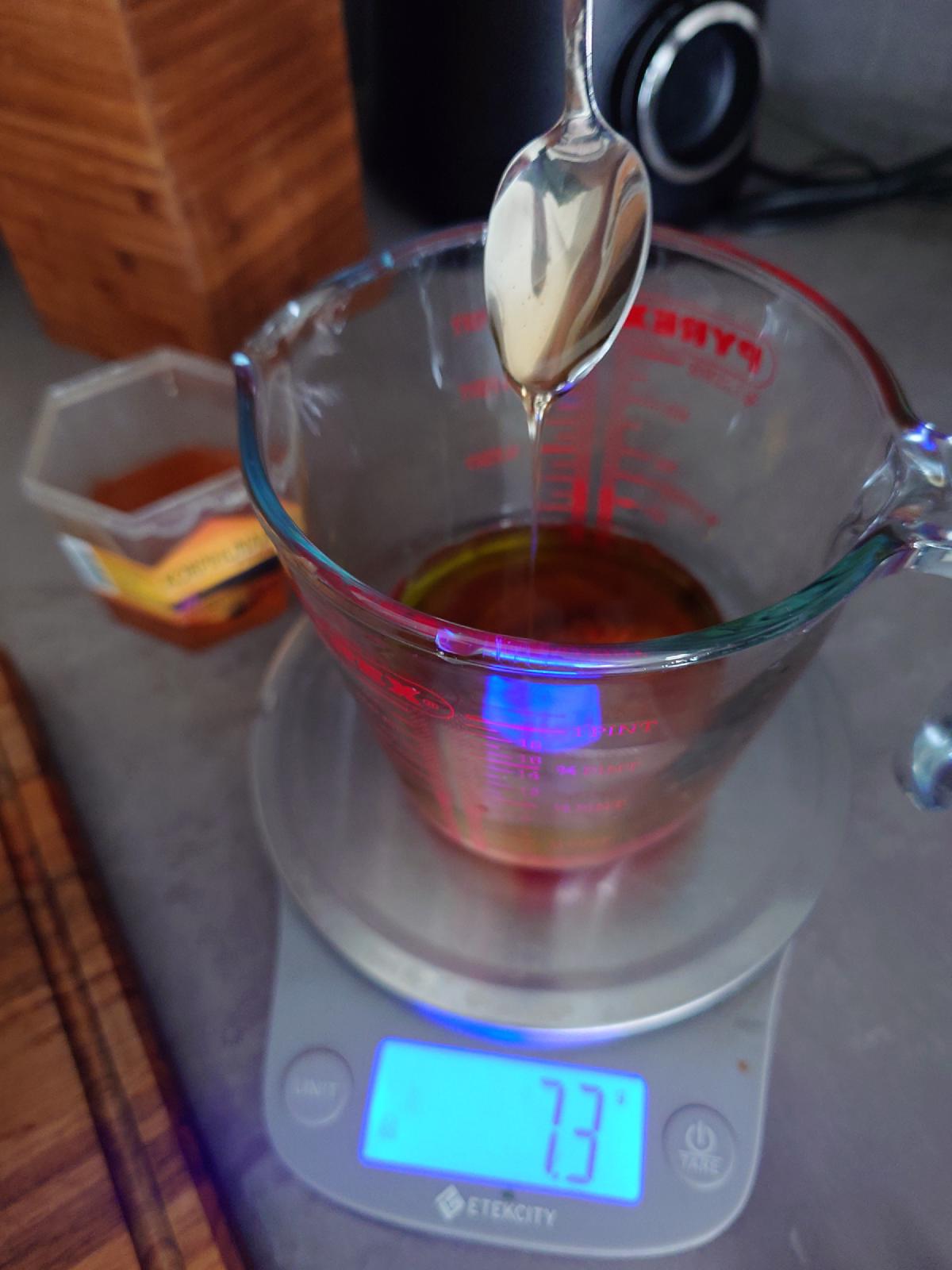 Honey spooned into the marinade