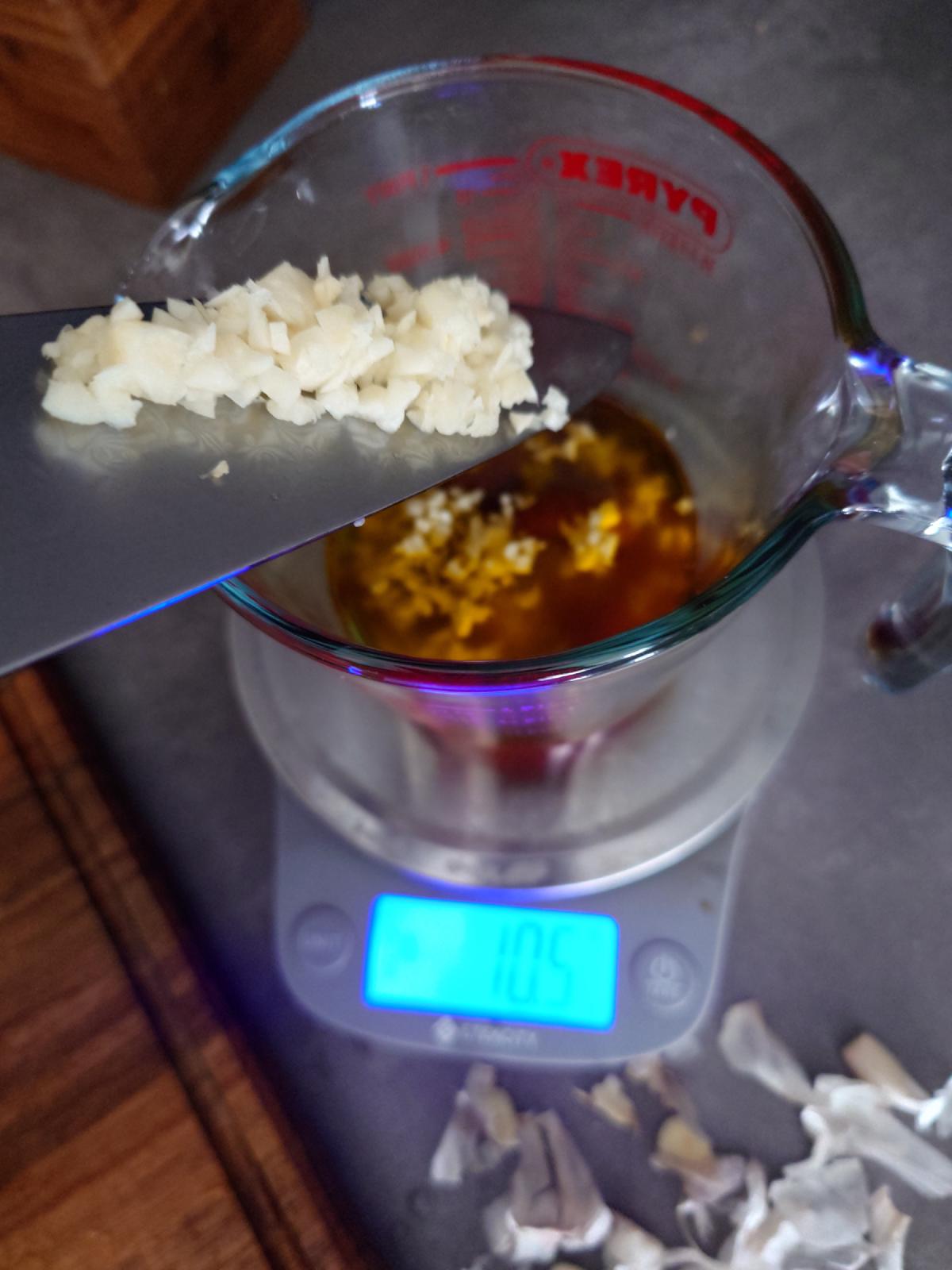 Minced garlic added on the knife