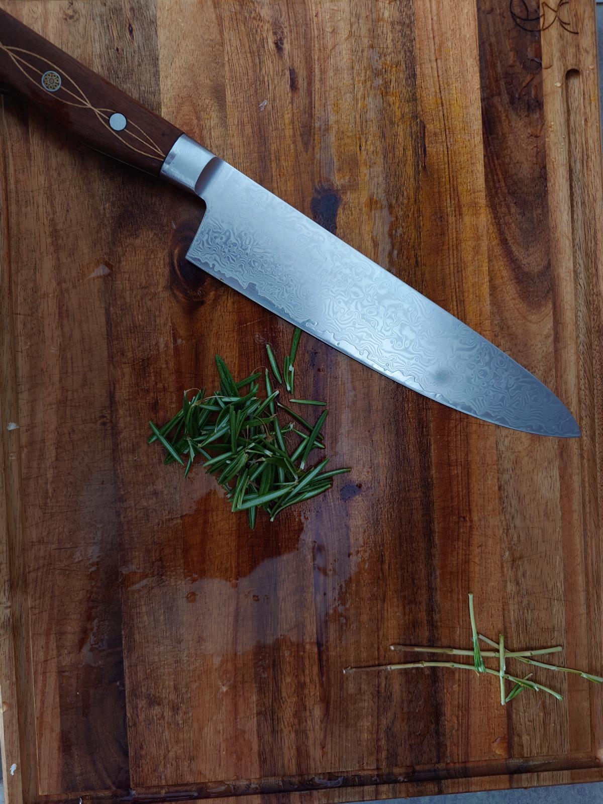 Rosemary needles chopped fine on the board