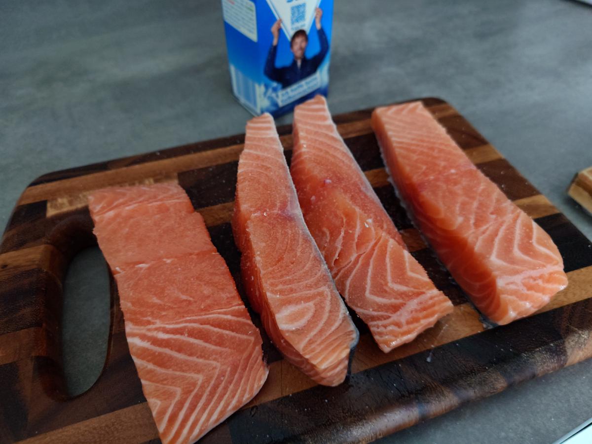 Four salmon fillets on the board