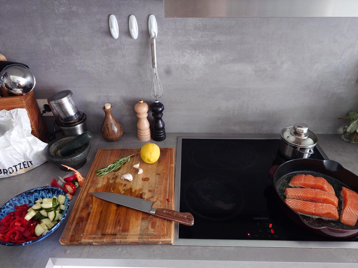 Salmon laid skin-side down in the pan