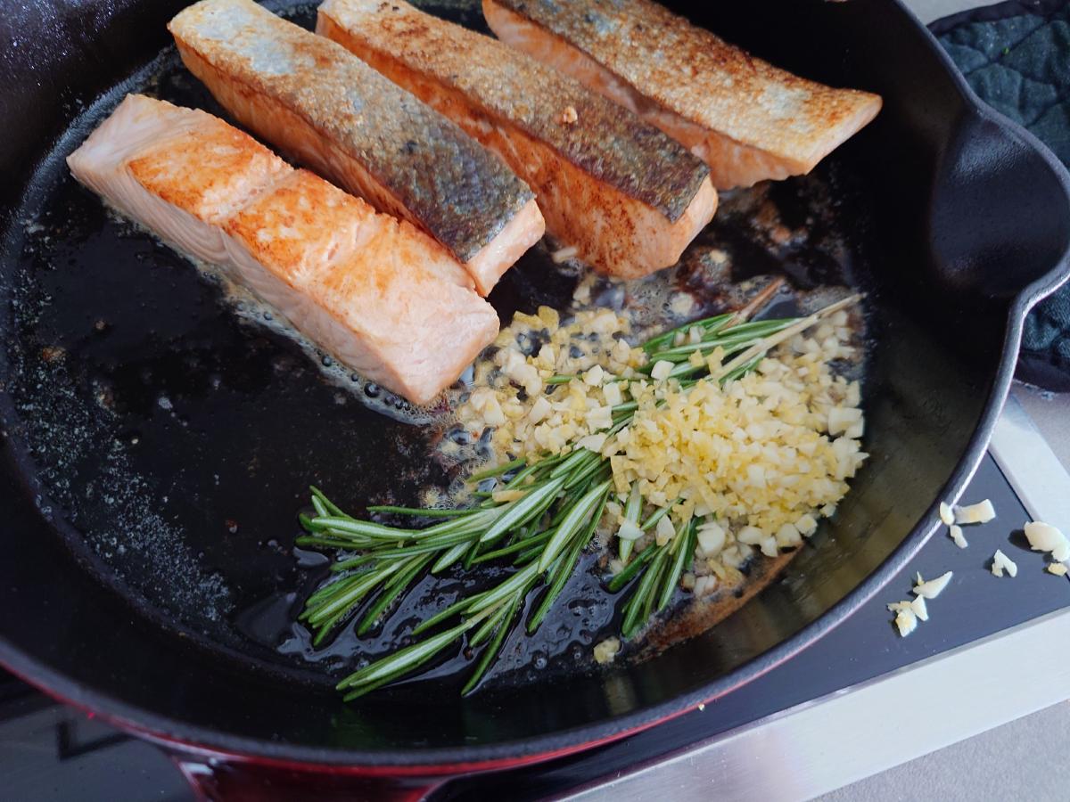 Garlic and rosemary added to the pan
