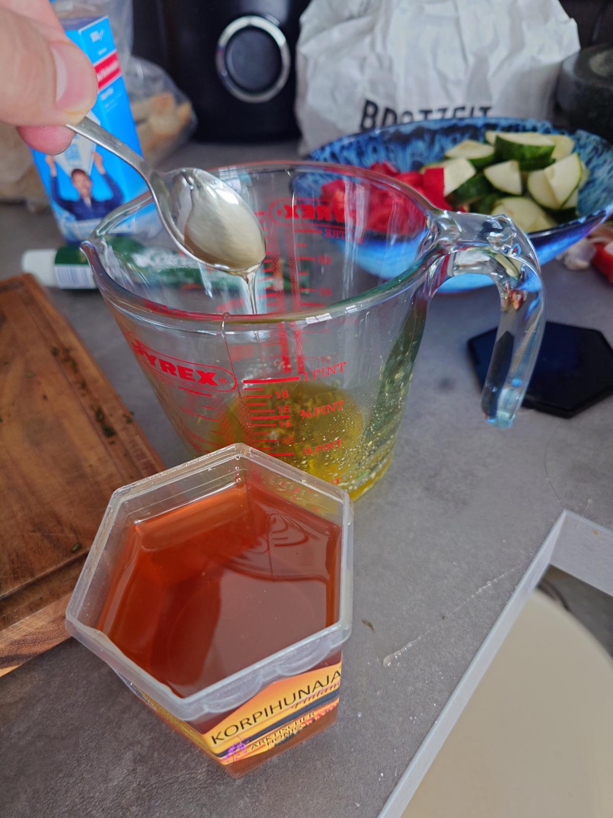 Honey spooned into the dressing