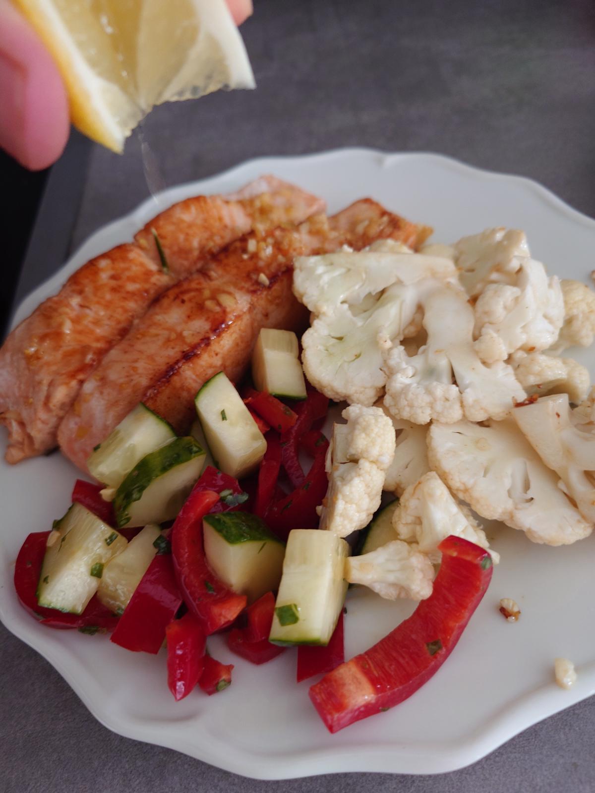 Plated salmon with cauliflower and the pepper-cucumber salad