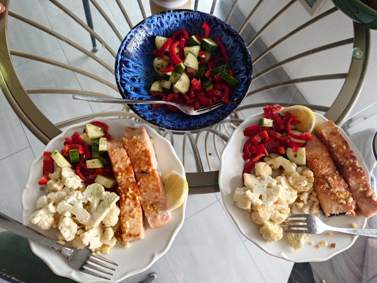 Both plates and the salad bowl on the table