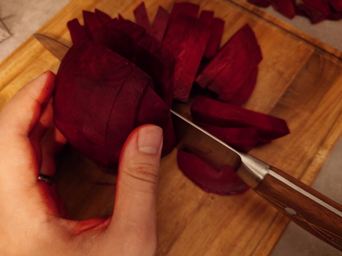 The peeled beet cut into batons on the board