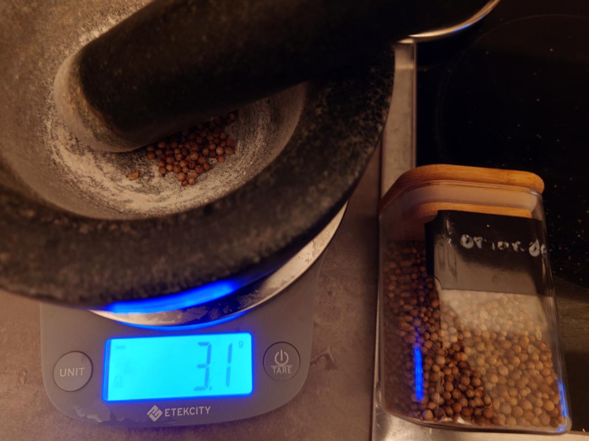 Coriander seed weighed in the mortar