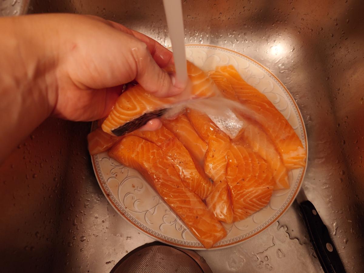 The salmon rinsed under running water