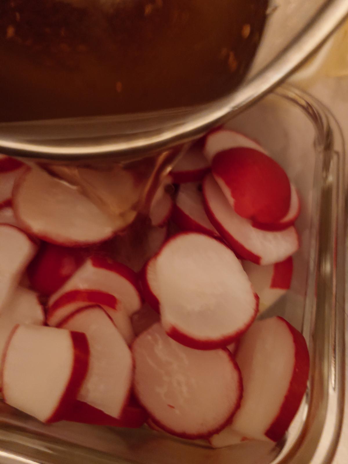 Brine poured over the sliced radishes