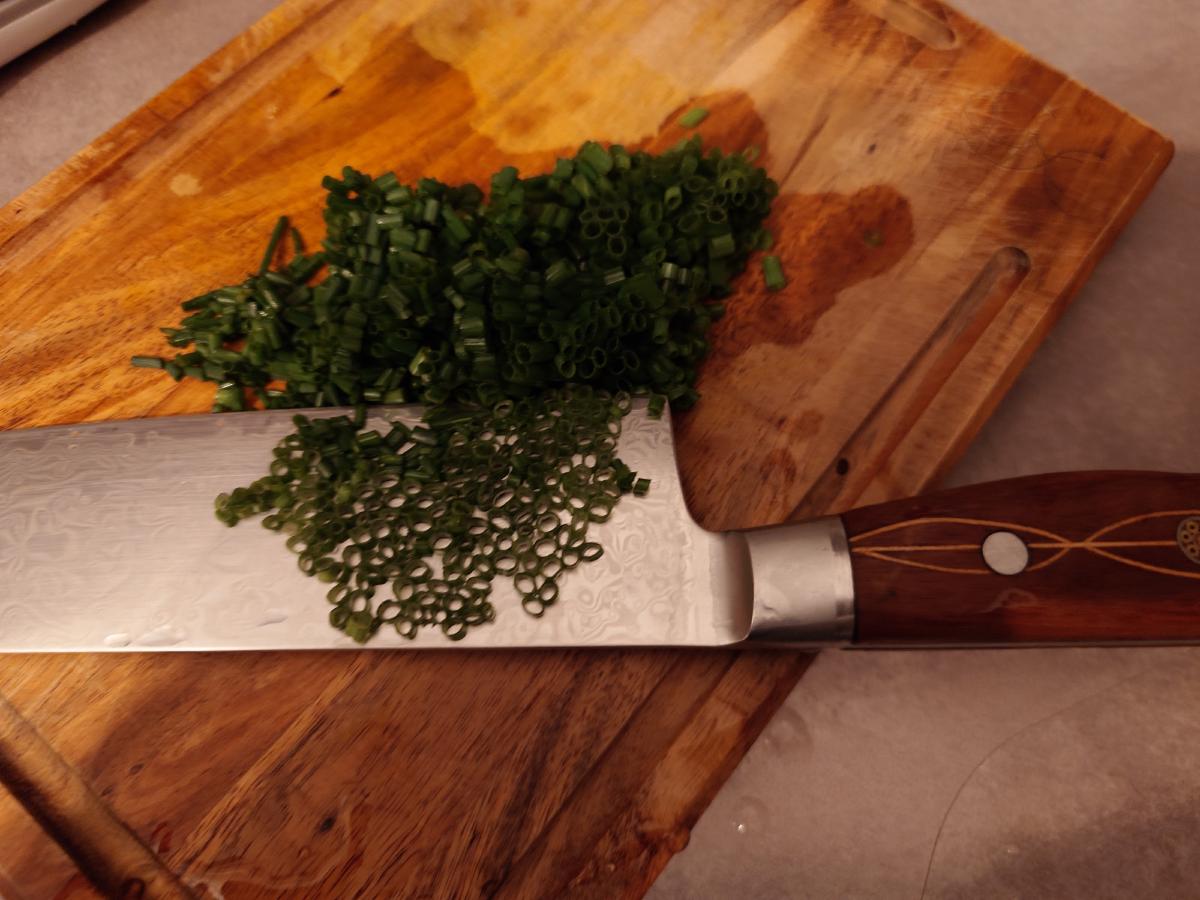 Chives sliced fine on the board