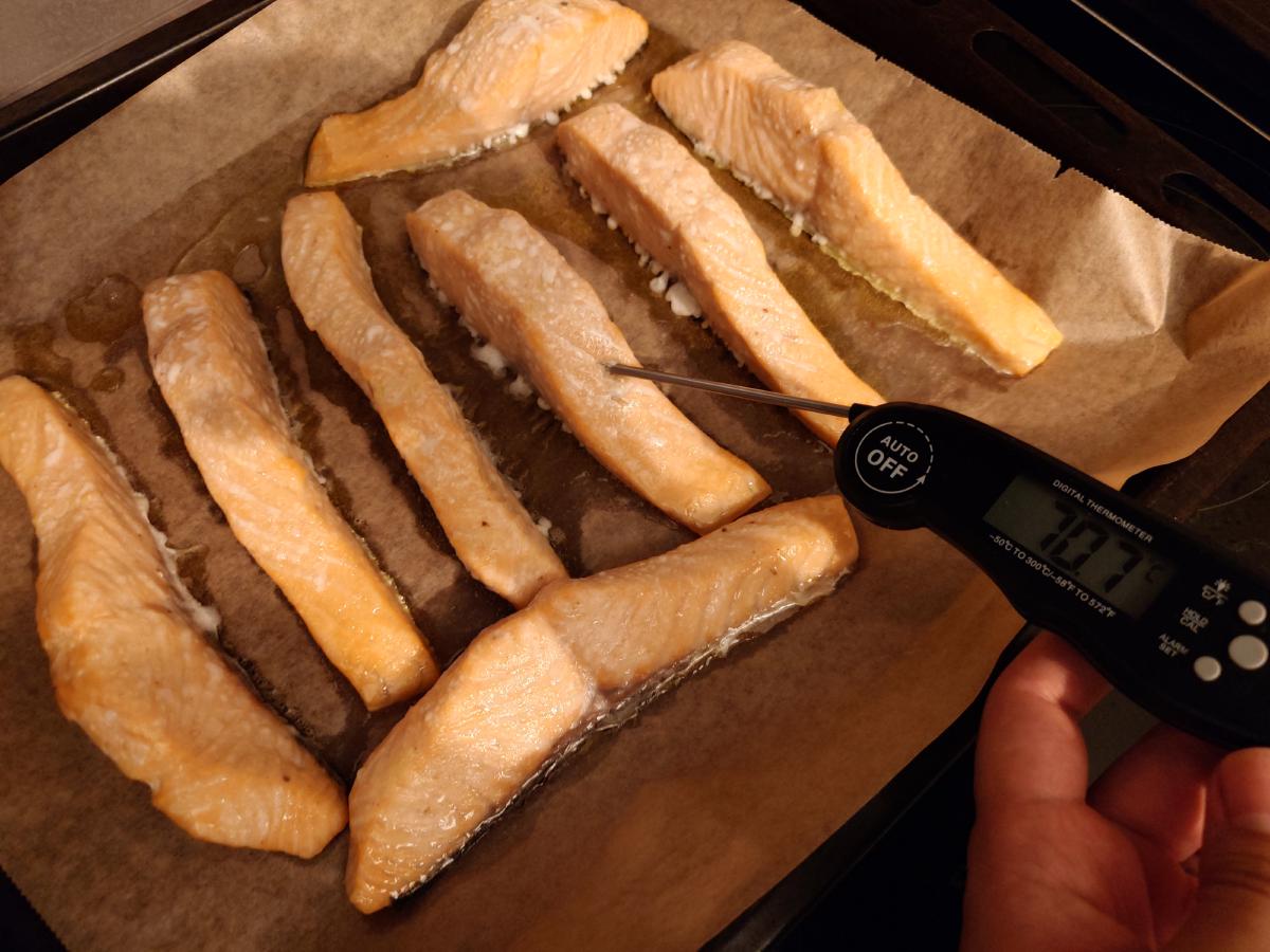 The salmon out of the oven, thermometer in the thickest piece