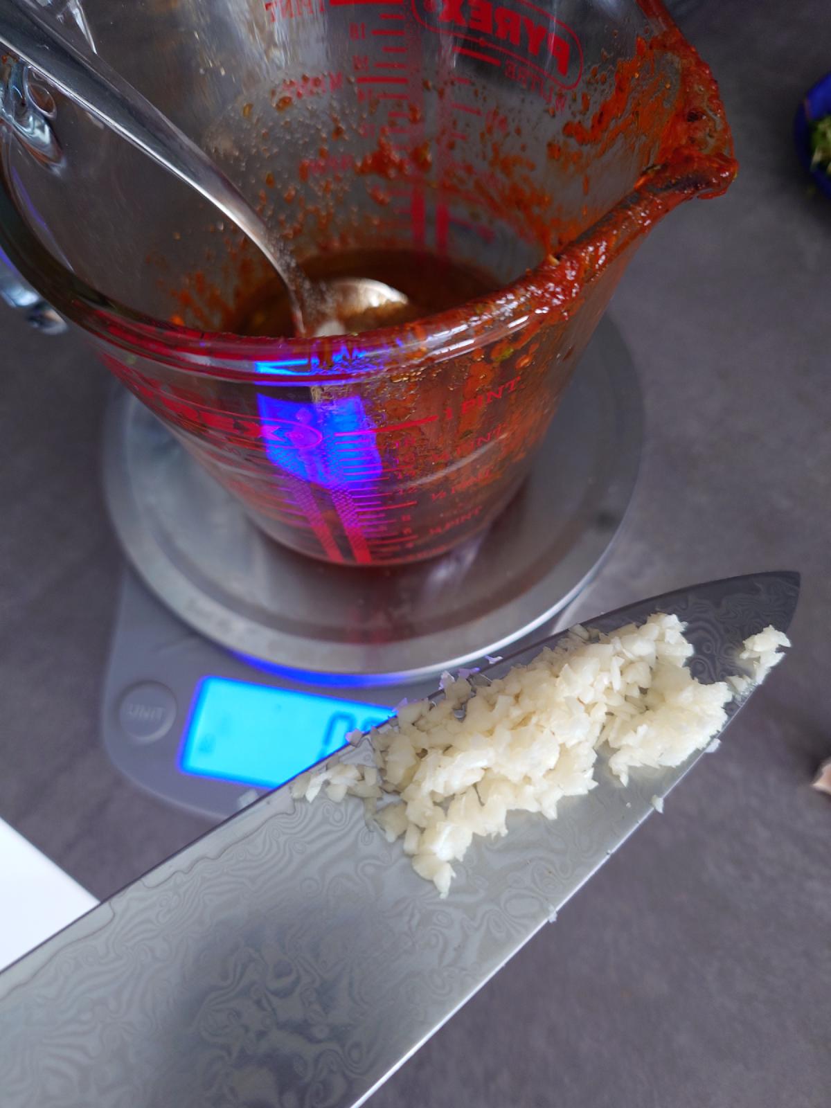 Minced garlic added on the knife