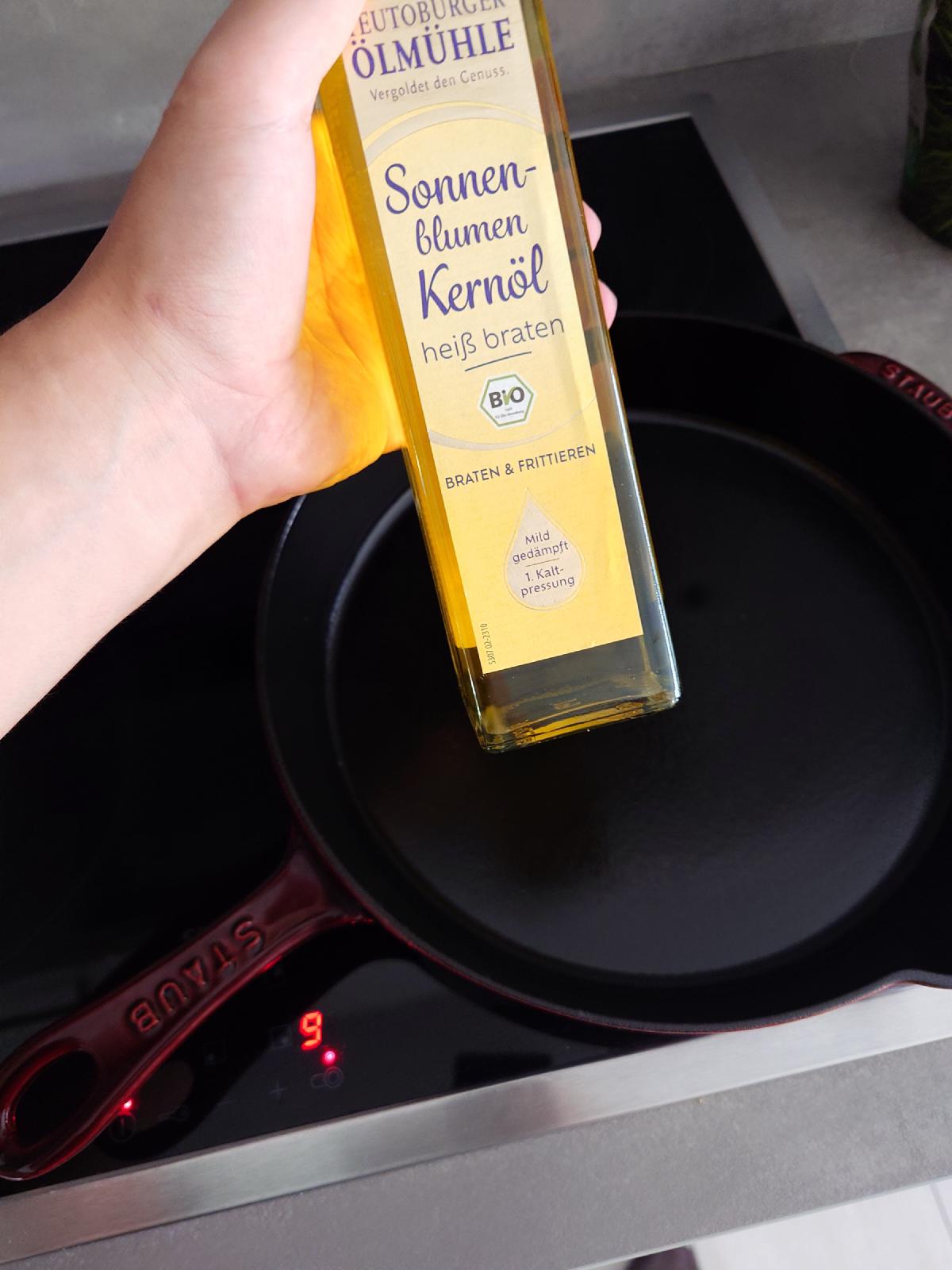 Sunflower oil going into the Staub pan