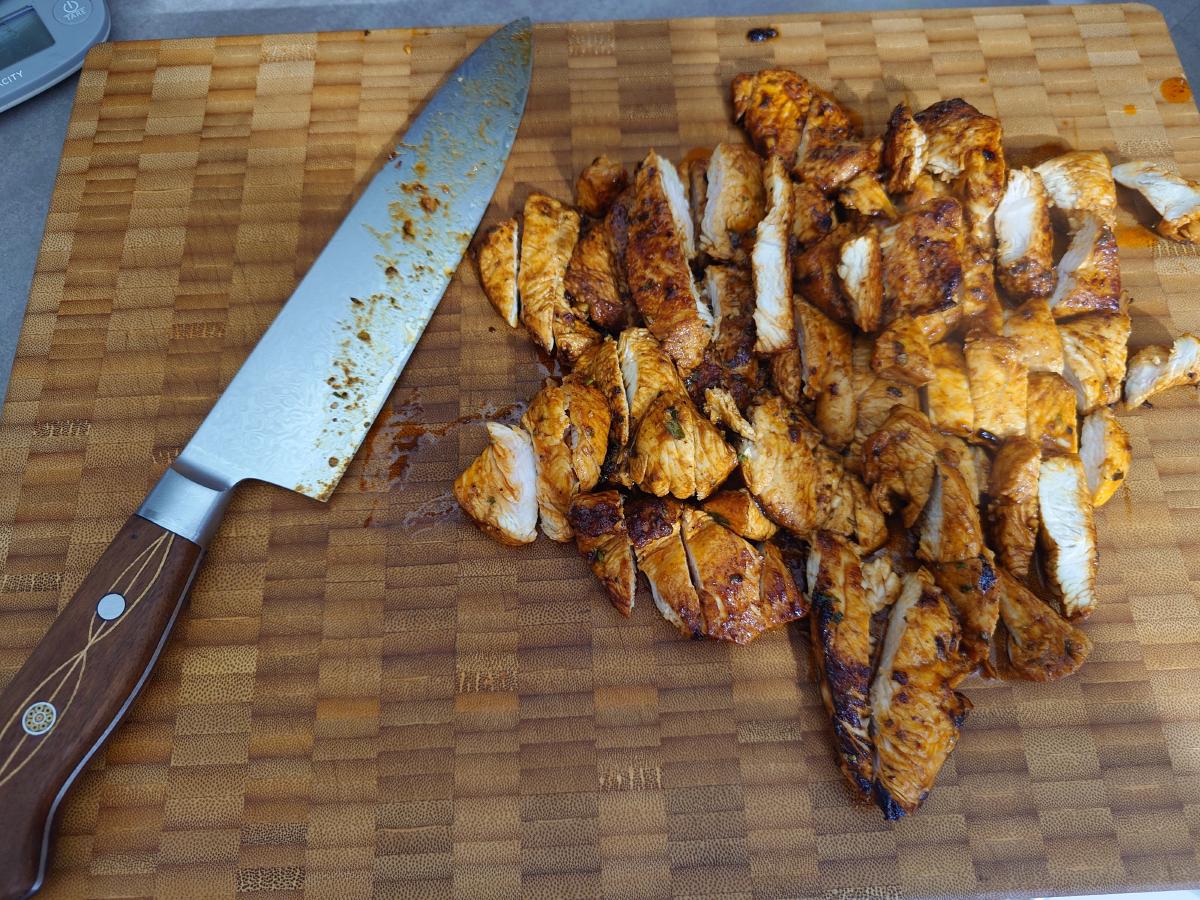The turkey rested and sliced on the board