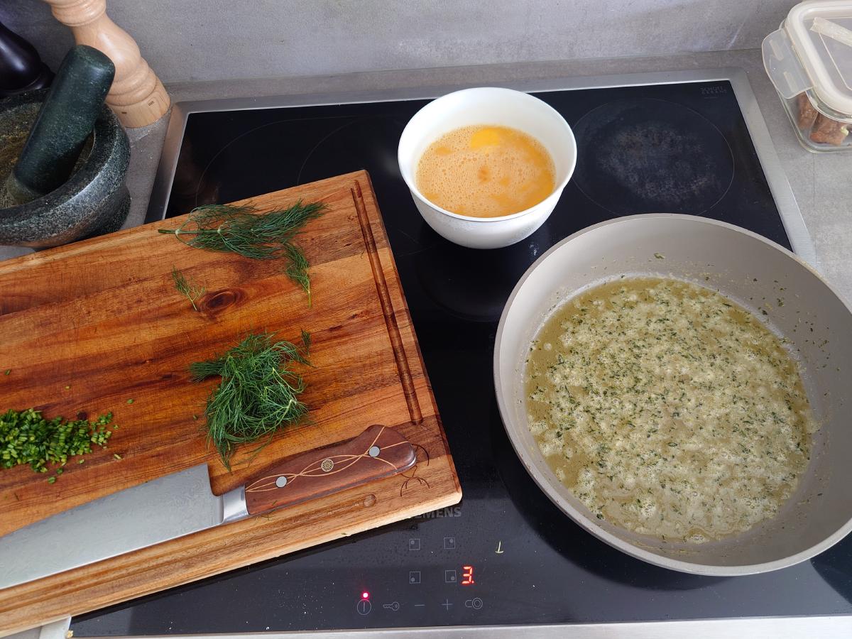 Thyme butter simmering, eggs and chopped herbs standing by