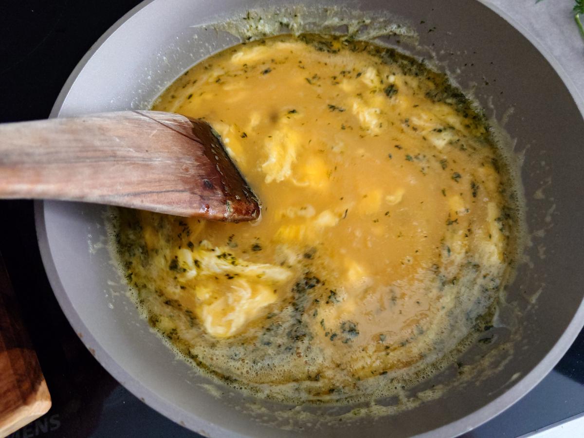 Eggs poured into the thyme butter