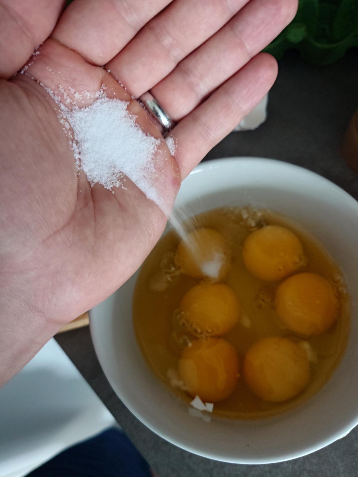 Salt going into the cracked eggs