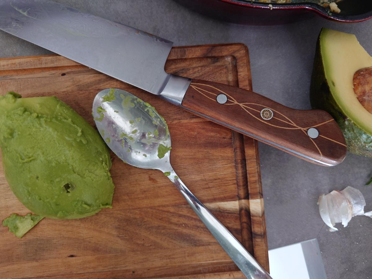 Avocado scooped and sliced on the board