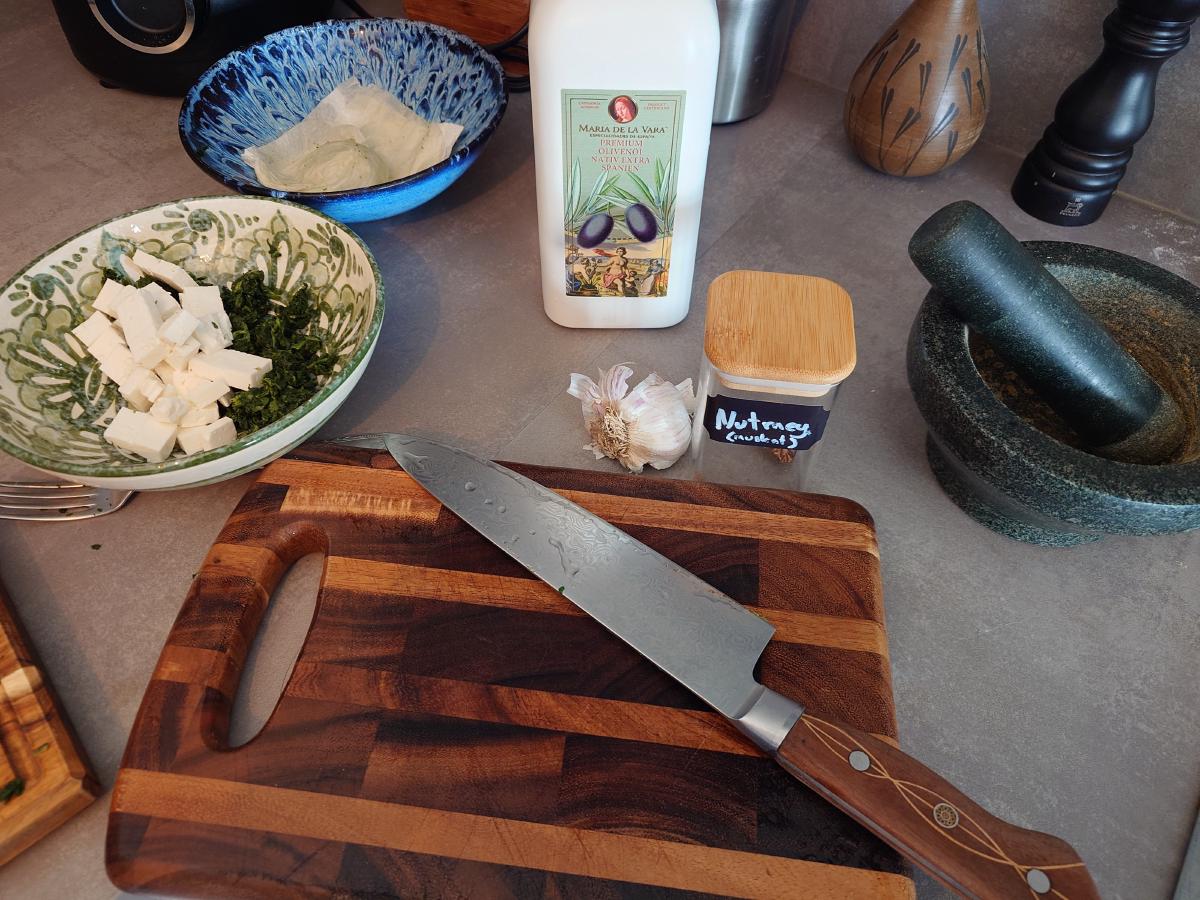 Feta, spinach, garlic and nutmeg set out on the counter