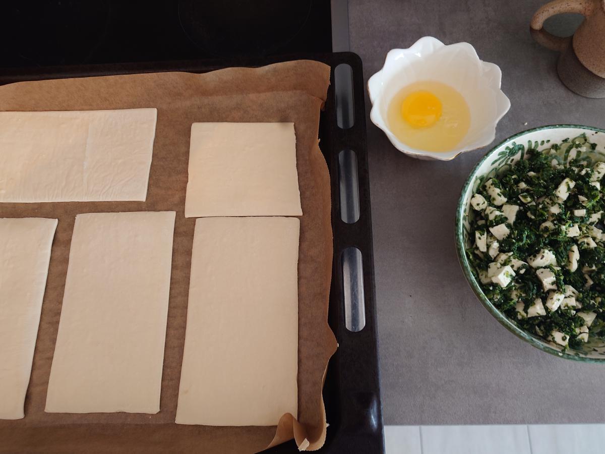 Puff pastry cut into rectangles with the egg and filling ready