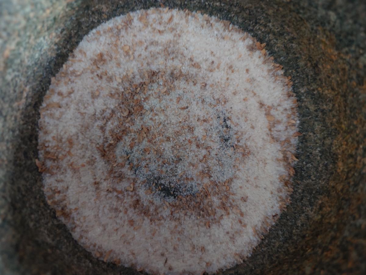 The mortar from above, coriander cracked into the salt