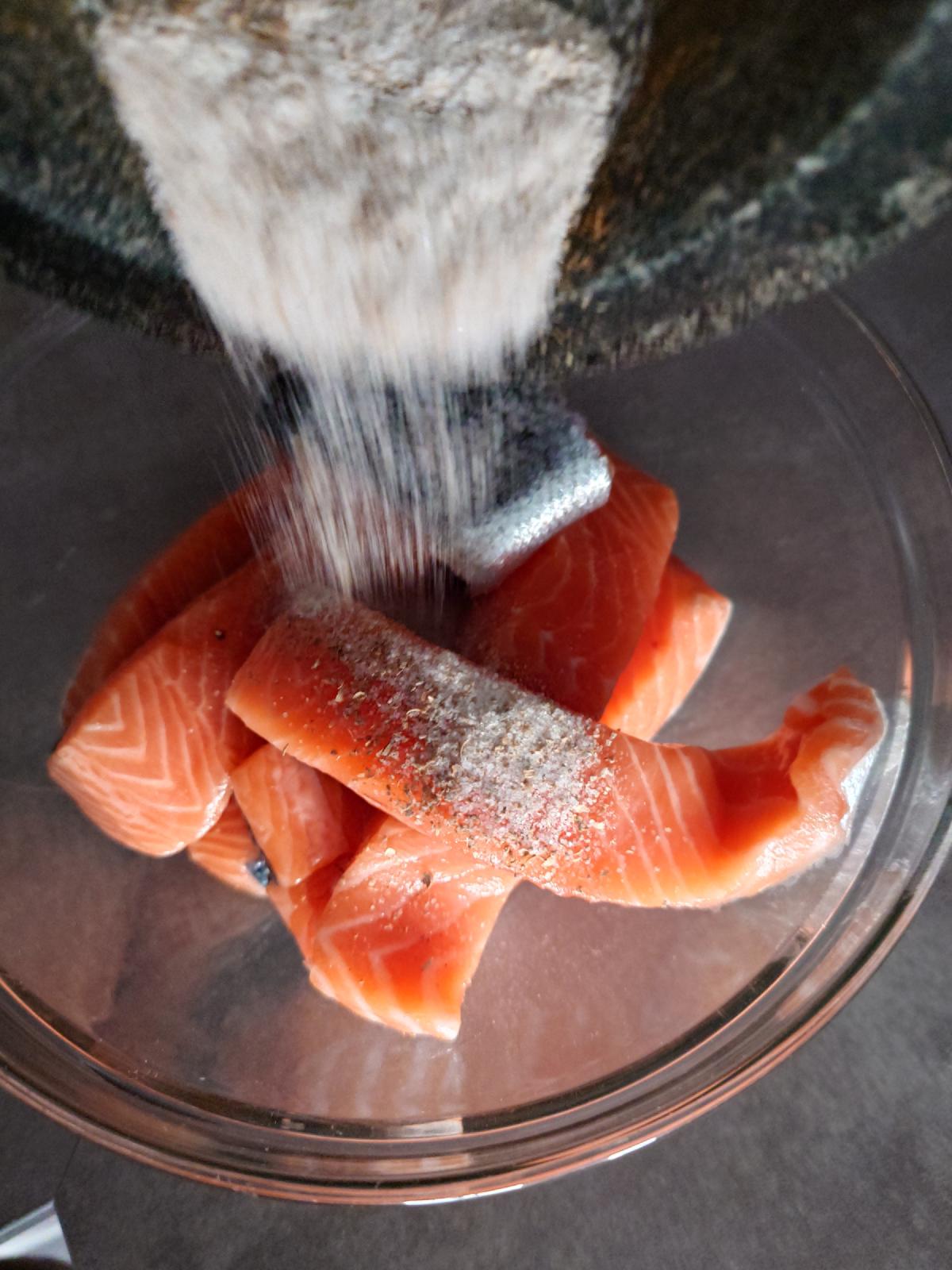 The mortar tipped over the bowl, the mix falling onto the salmon