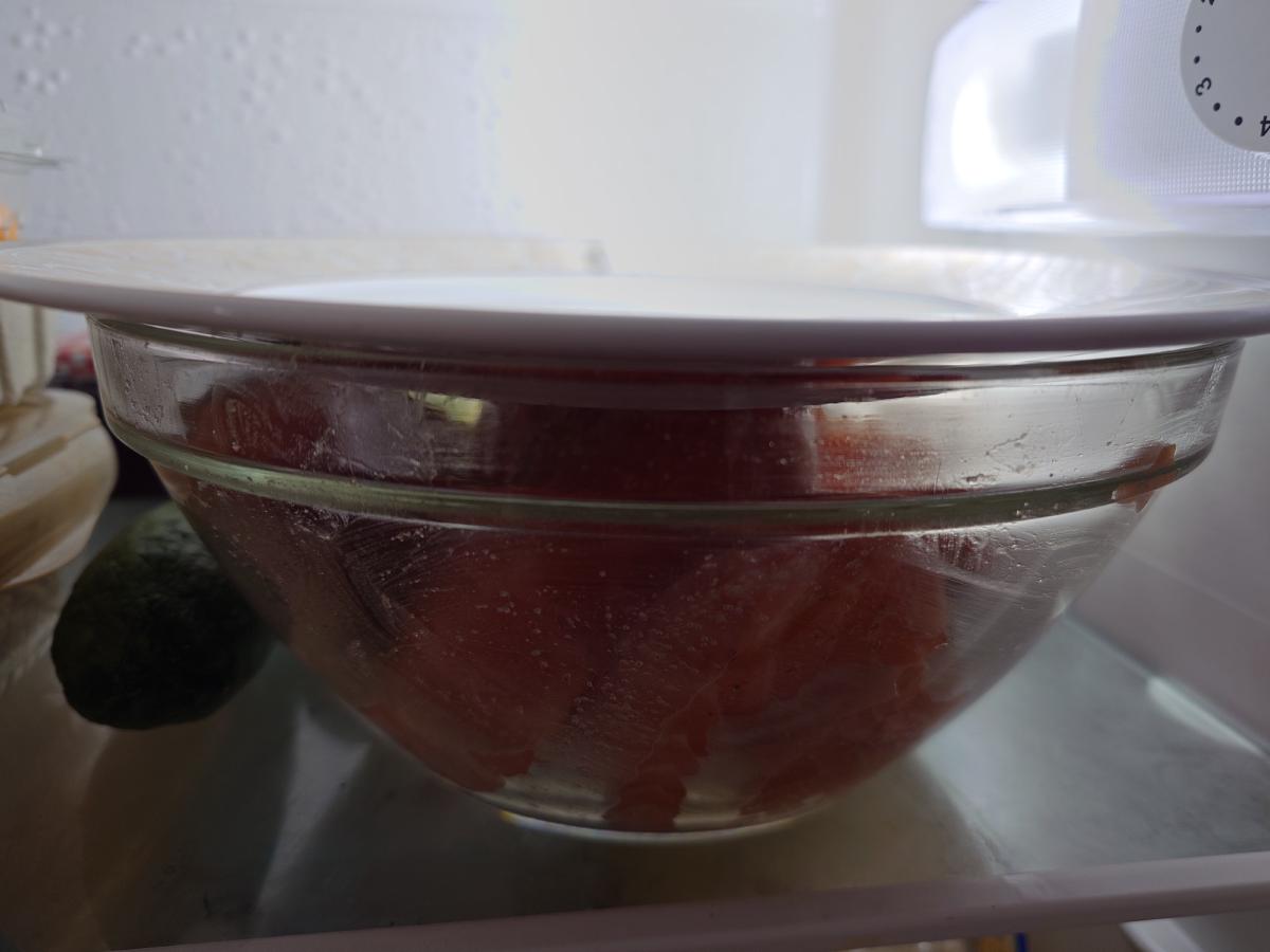 The covered bowl on a fridge shelf