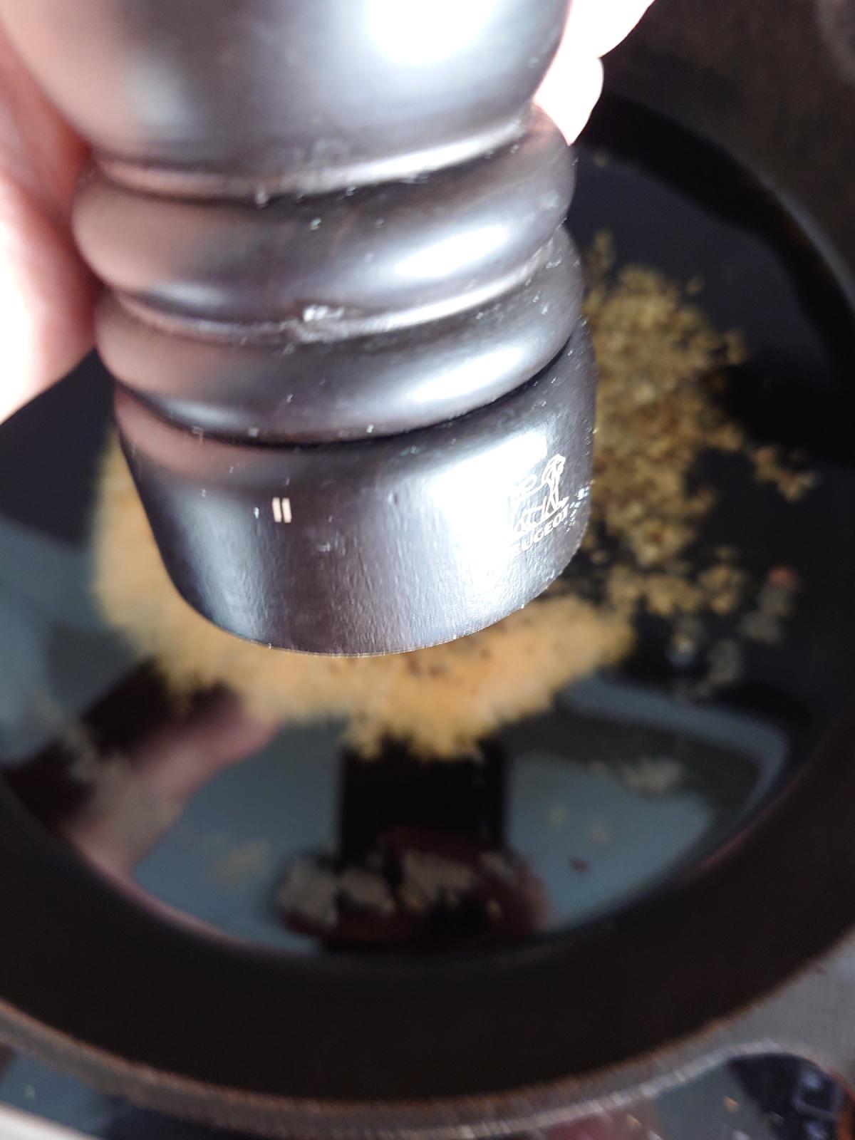 The pepper mill grinding over the pan