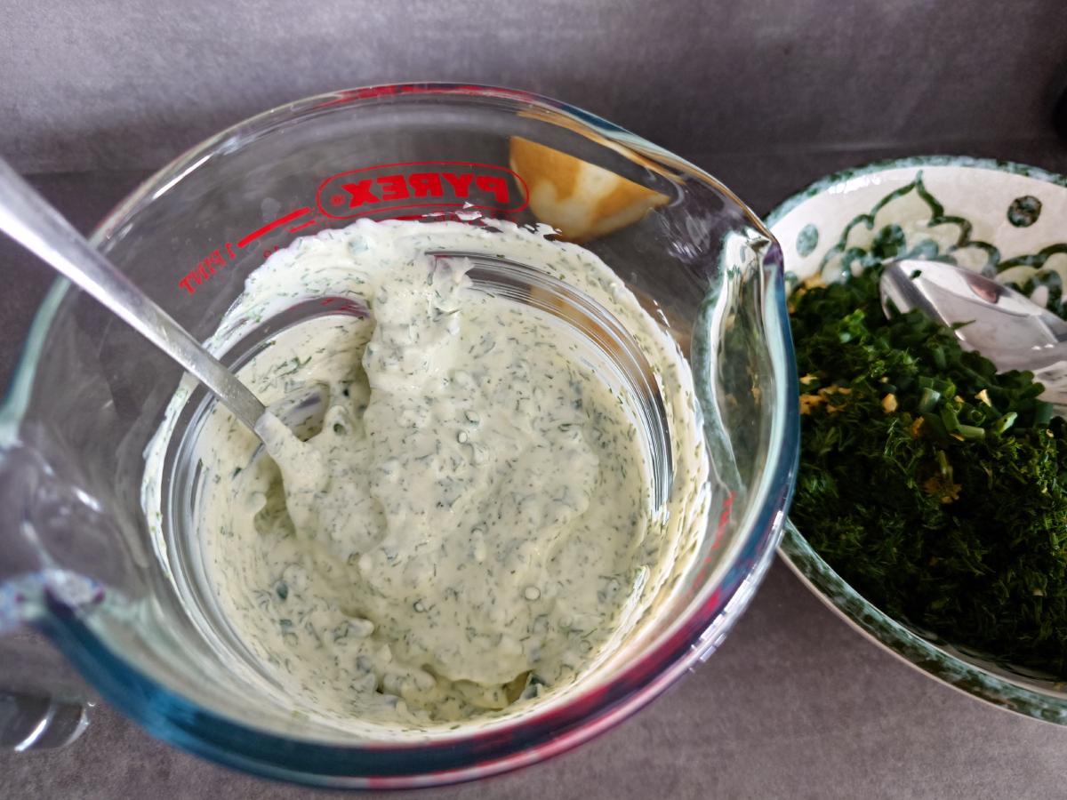 The sauce stirred, green through the white, squeezed lemon wedge in the jug