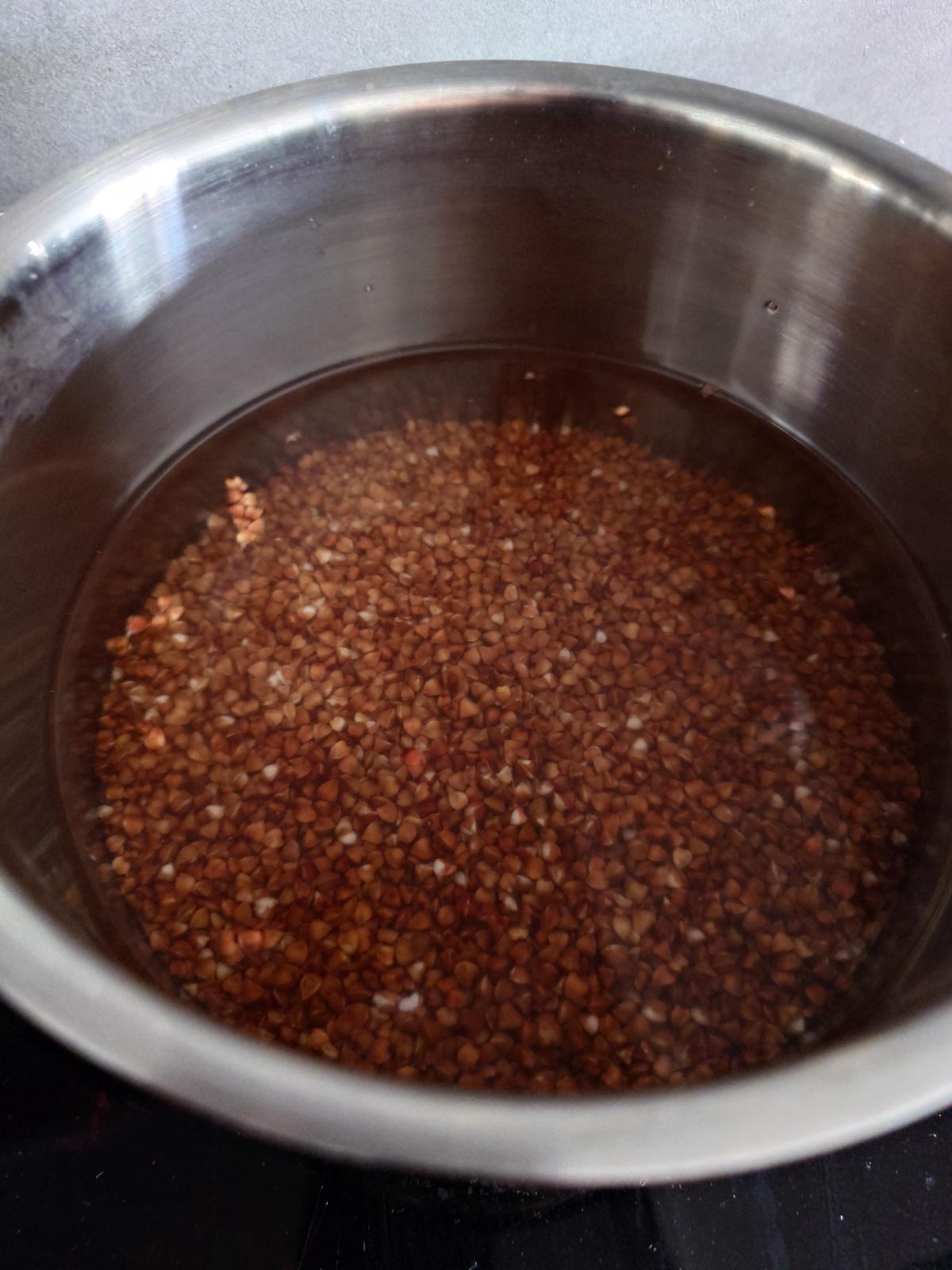 Buckwheat under water in a steel pot